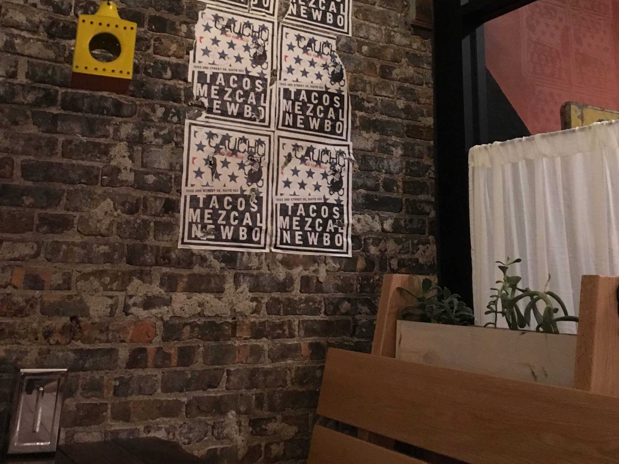 Graffiti posters on the exposed brick walls at Caucho